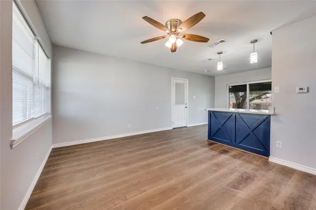 a view of a livingroom with a furniture hardwood floor and a ceiling fan