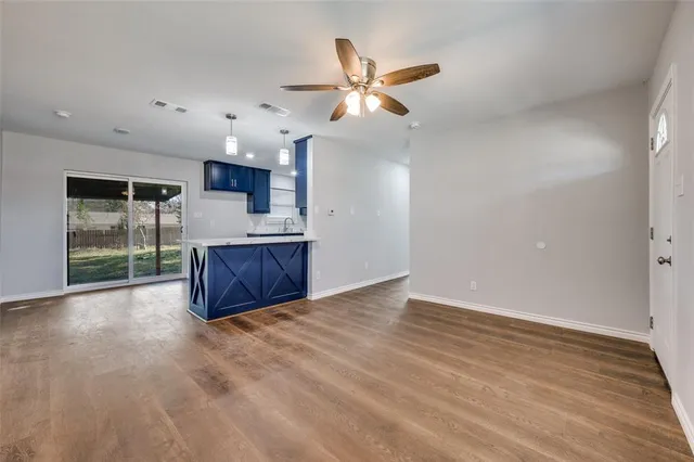 a kitchen with stainless steel appliances kitchen island granite countertop a stove a sink and a refrigerator
