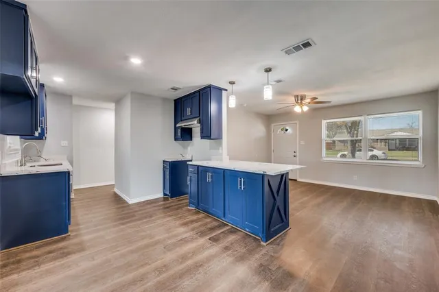 a kitchen with a stove a refrigerator a sink and a cabinets
