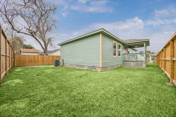 a front view of house with backyard and green space
