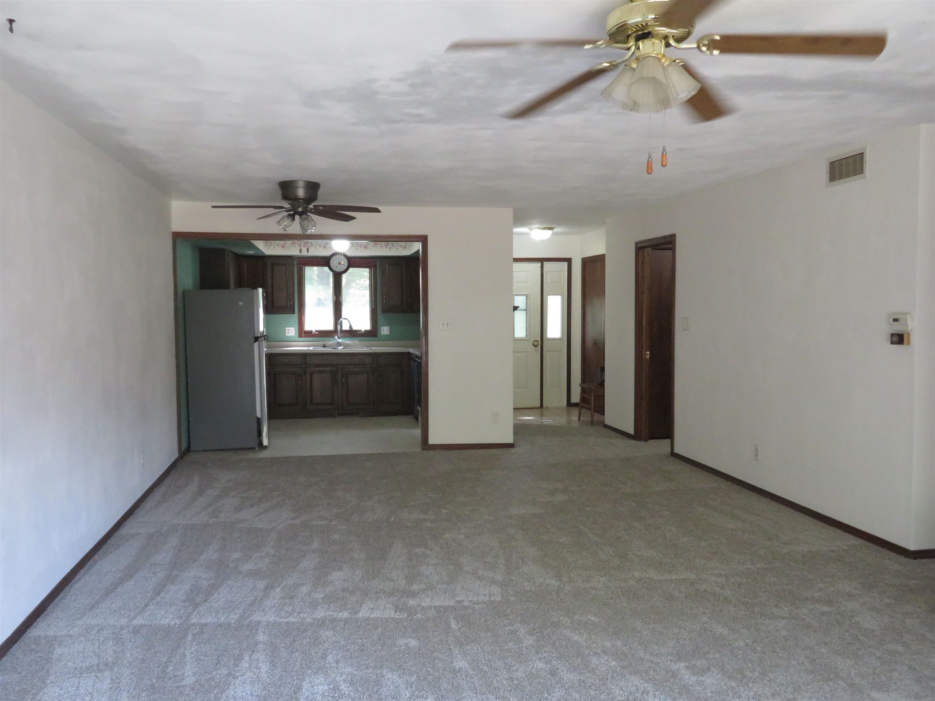 706 Quail Ridge Drive Freeport, IL 61032 - Photo 4 of 21 wooden floor in an empty room with a window