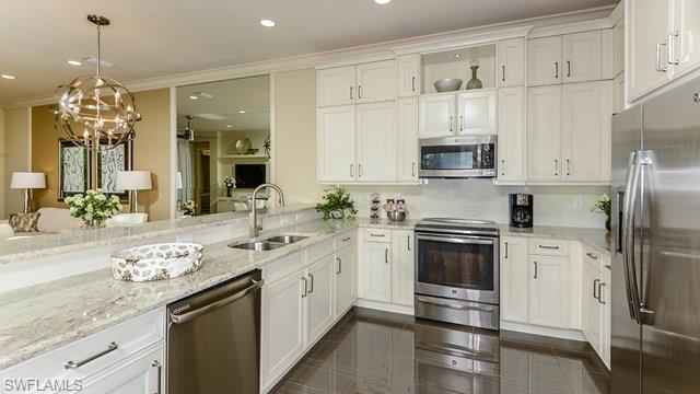 13338 Coronado Drive Naples, FL 34109 - Photo 3 of 19 a kitchen with a sink stove and refrigerator