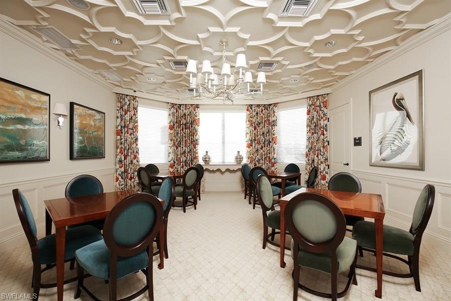 13338 Coronado Drive Naples, FL 34109 - Photo 9 of 19 a dining room with furniture a chandelier and wooden floor