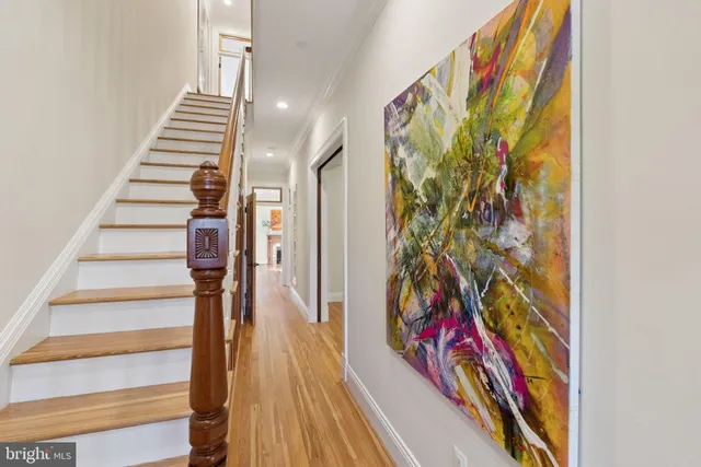 a kitchen with a table chairs and white cabinets