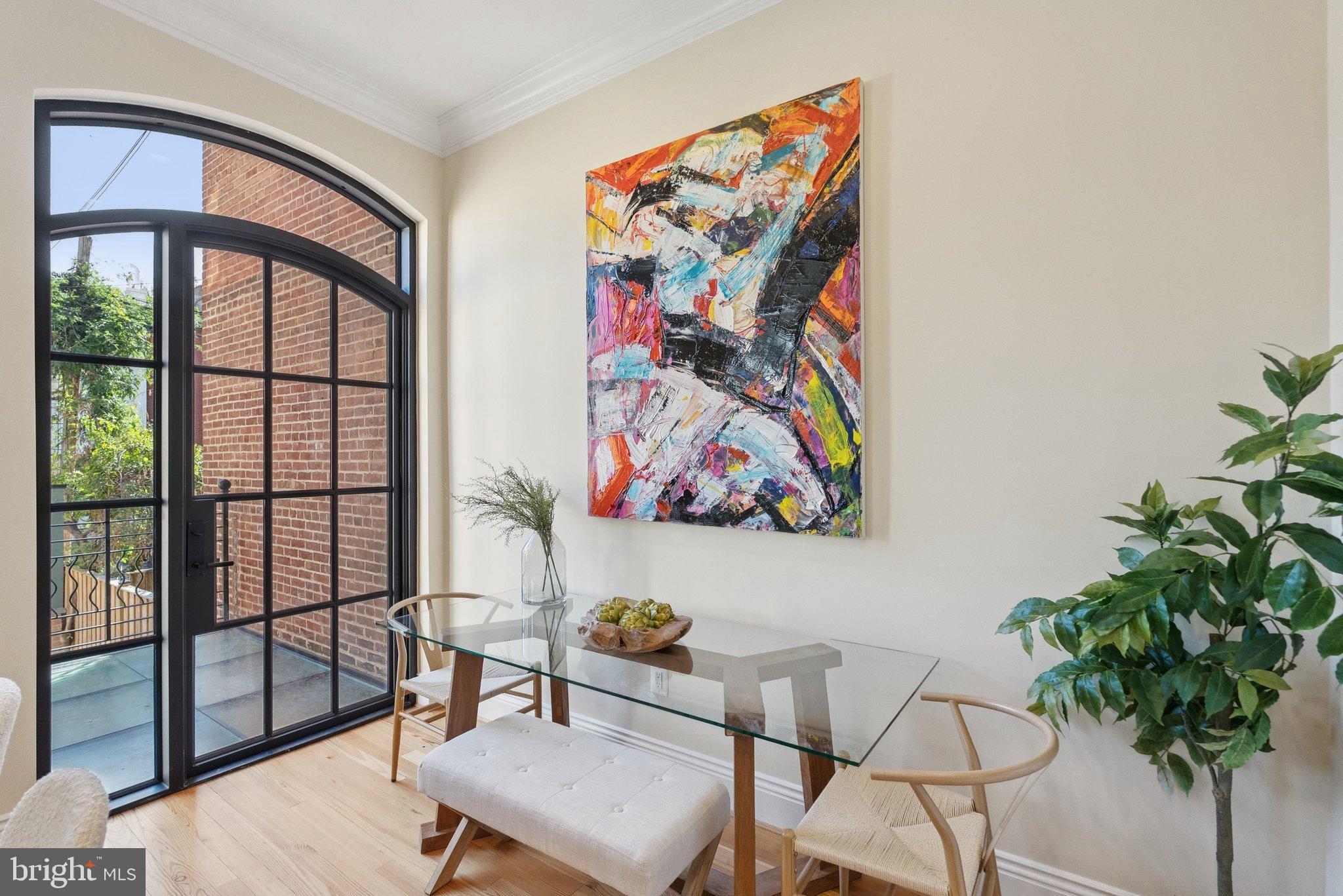 1514 R Street Northwest Washington, DC 20009 - Photo 16 of 84 a view of a workspace room with furniture and a potted plant