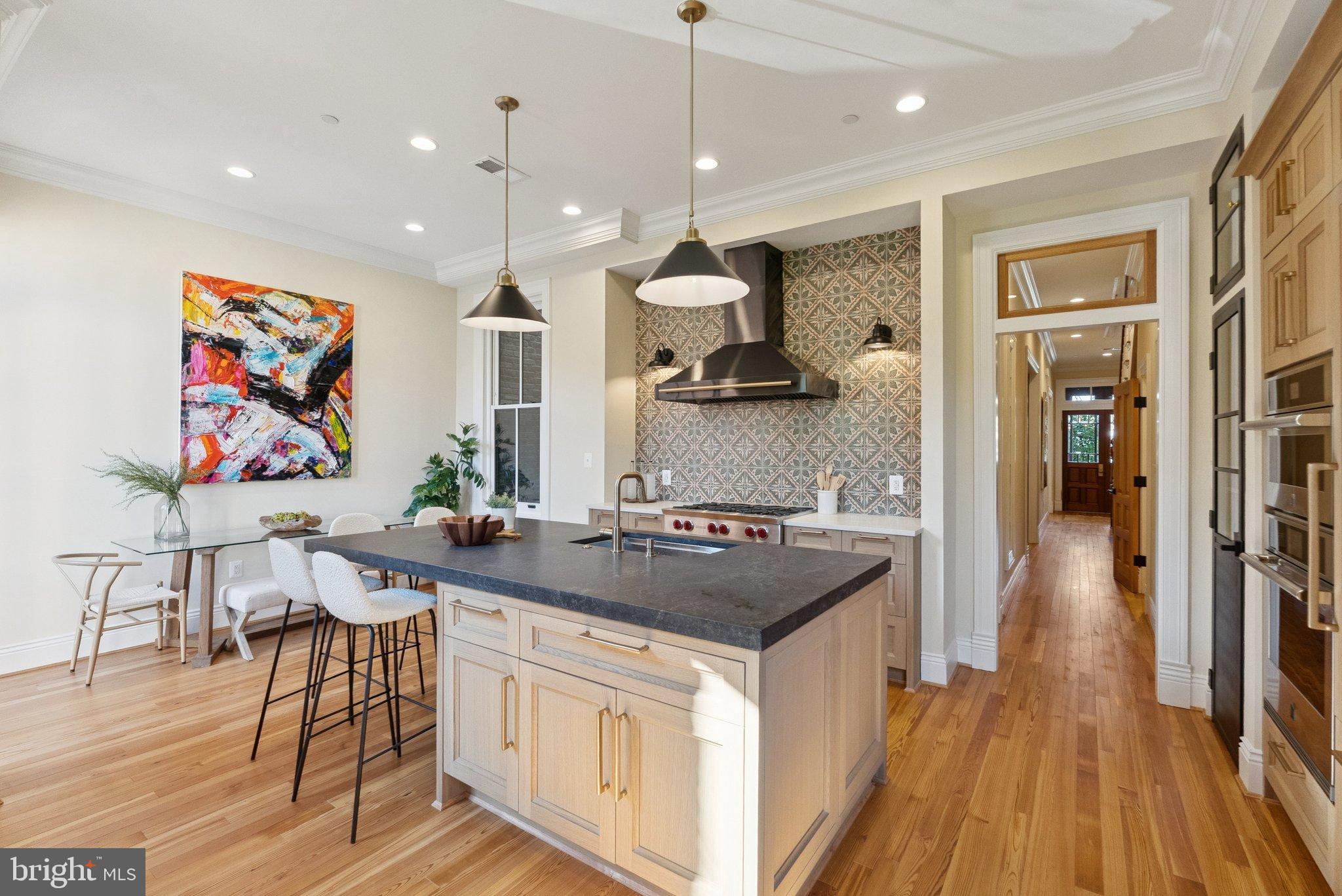 1514 R Street Northwest Washington, DC 20009 - Photo 21 of 84 a kitchen with stainless steel appliances granite countertop a stove a sink a refrigerator and a wooden cabinets