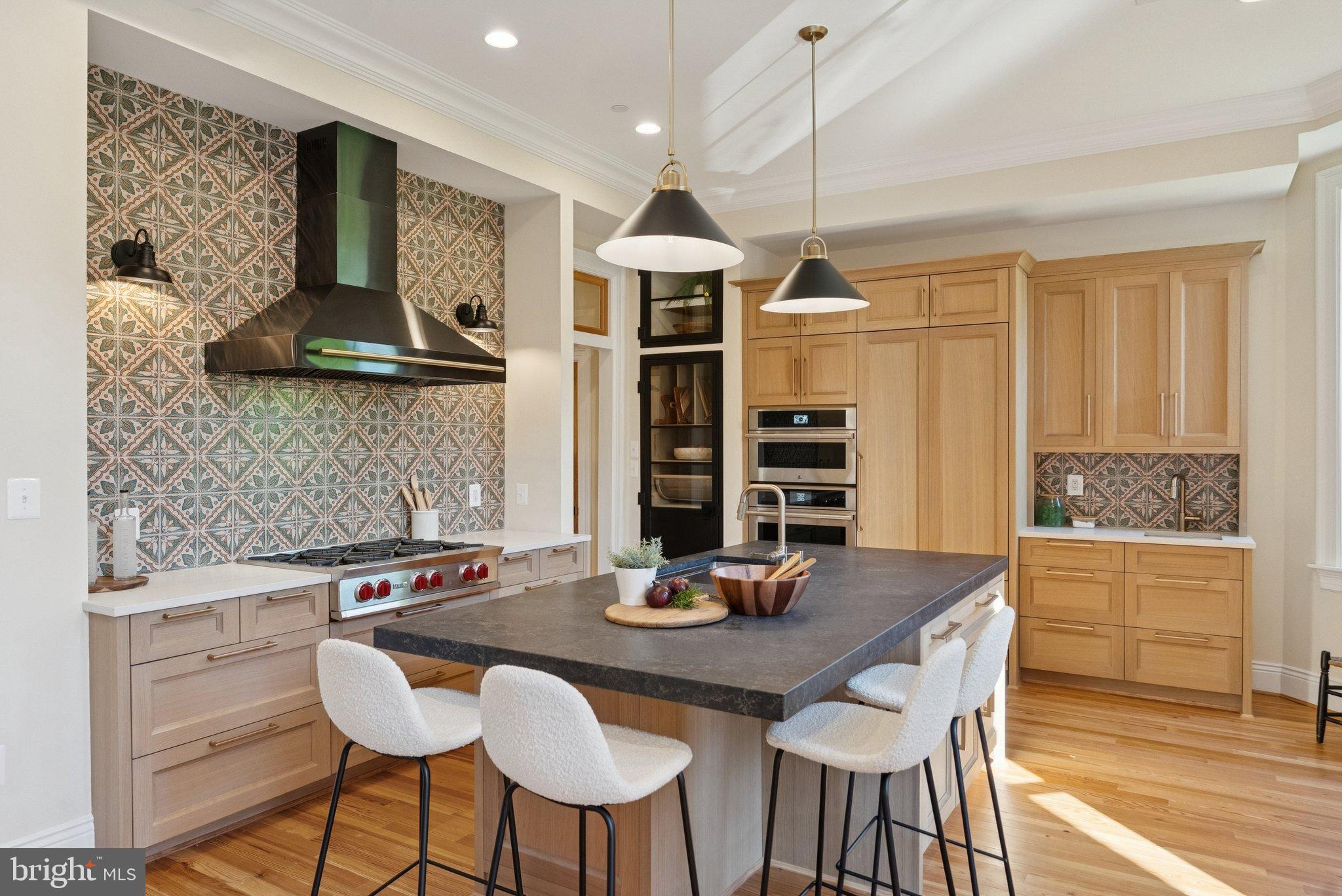 1514 R Street Northwest Washington, DC 20009 - Photo 22 of 84 a kitchen with a table chairs and white cabinets