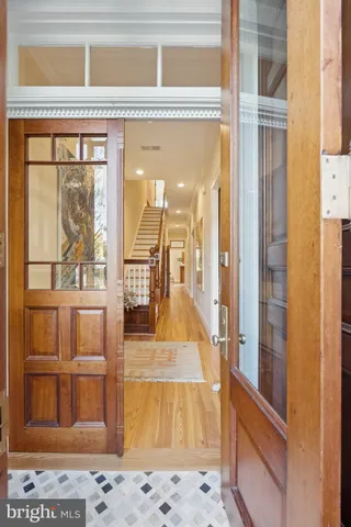 a view of a livingroom with wooden floor and a fireplace