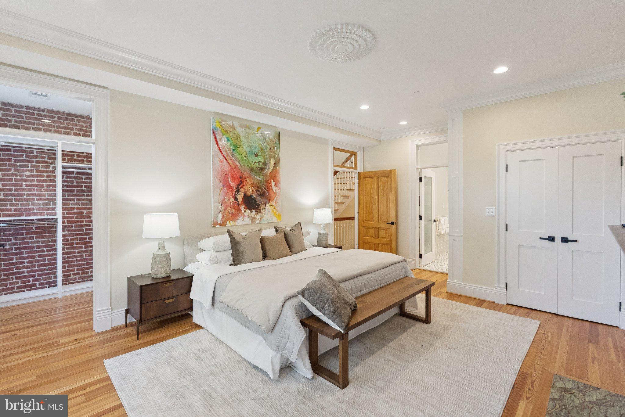 1514 R Street Northwest Washington, DC 20009 - Photo 29 of 84 a spacious bedroom with a bed and a painting on the wall