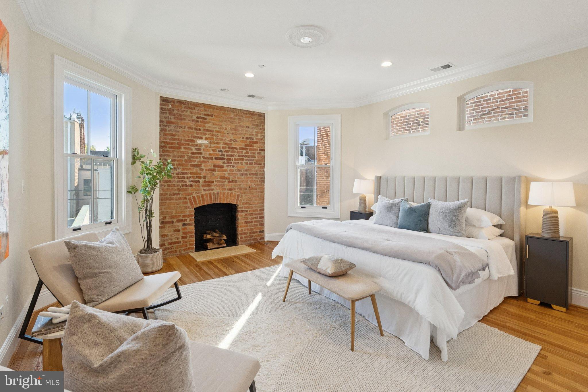 1514 R Street Northwest Washington, DC 20009 - Photo 37 of 84 a spacious bedroom with a bed and a fireplace
