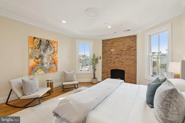 a living room with furniture a rug and white walls