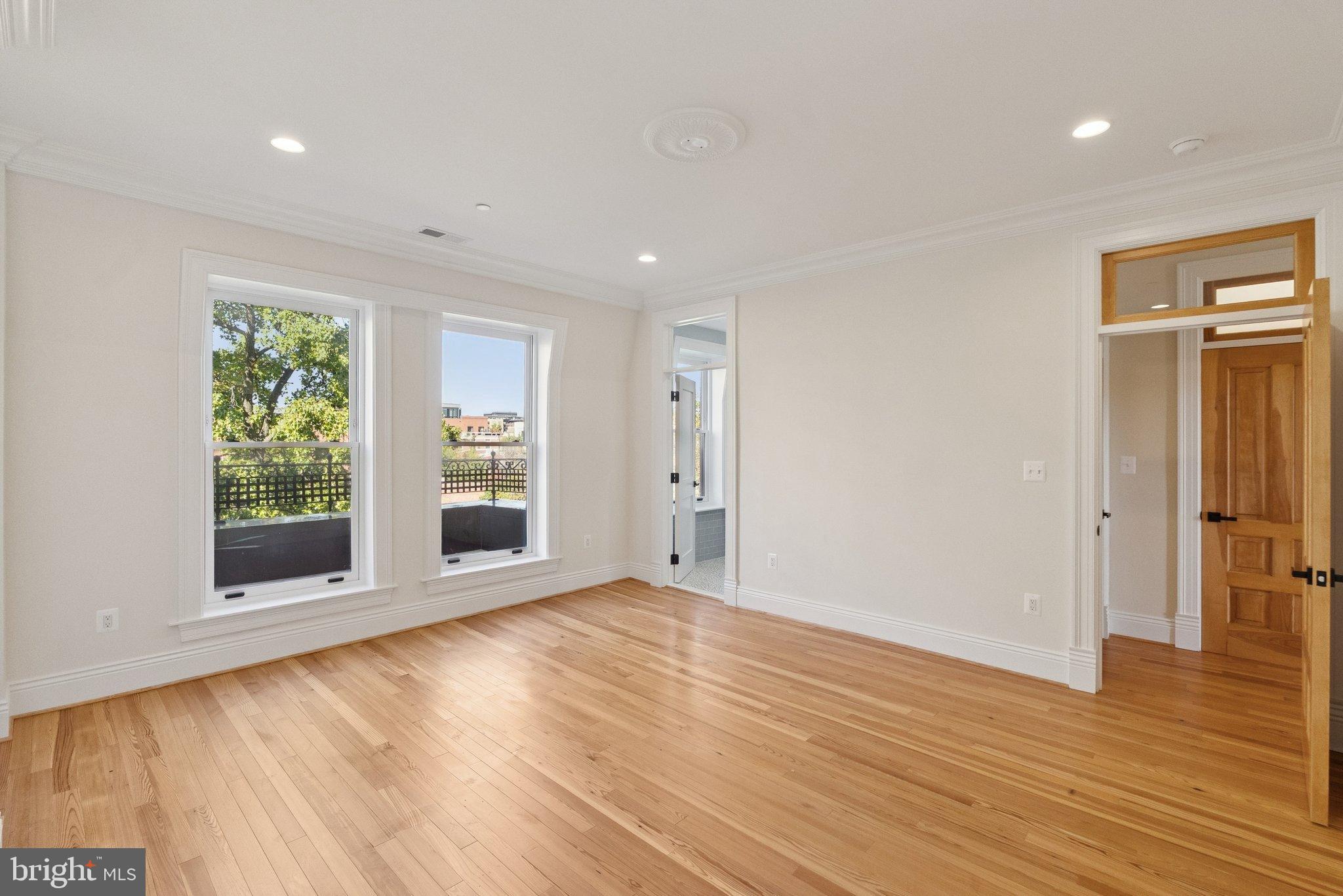 1514 R Street Northwest Washington, DC 20009 - Photo 48 of 84 a view of an empty room with wooden floor and a window