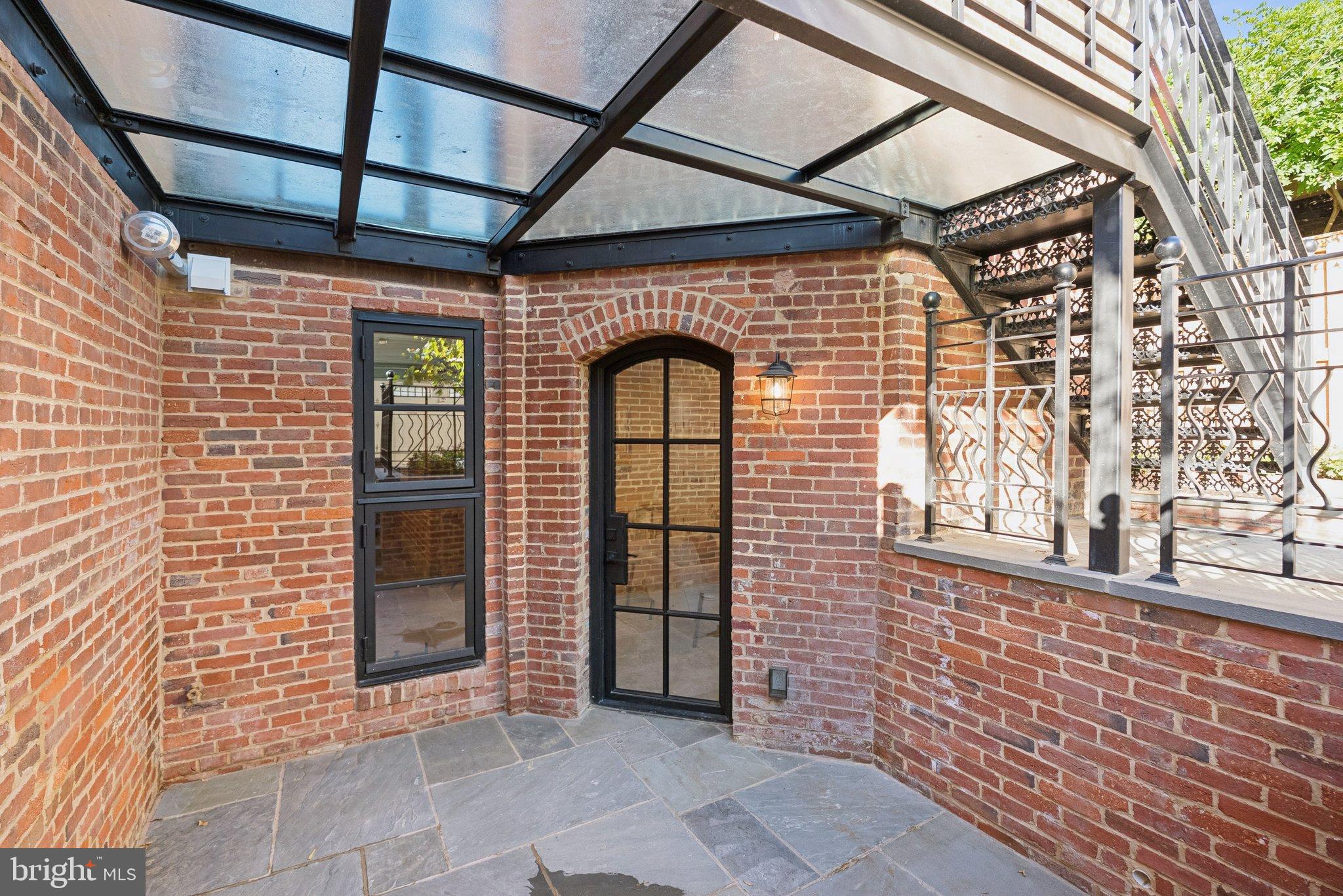 1514 R Street Northwest Washington, DC 20009 - Photo 73 of 84 Charming brick patio with elegant archway.