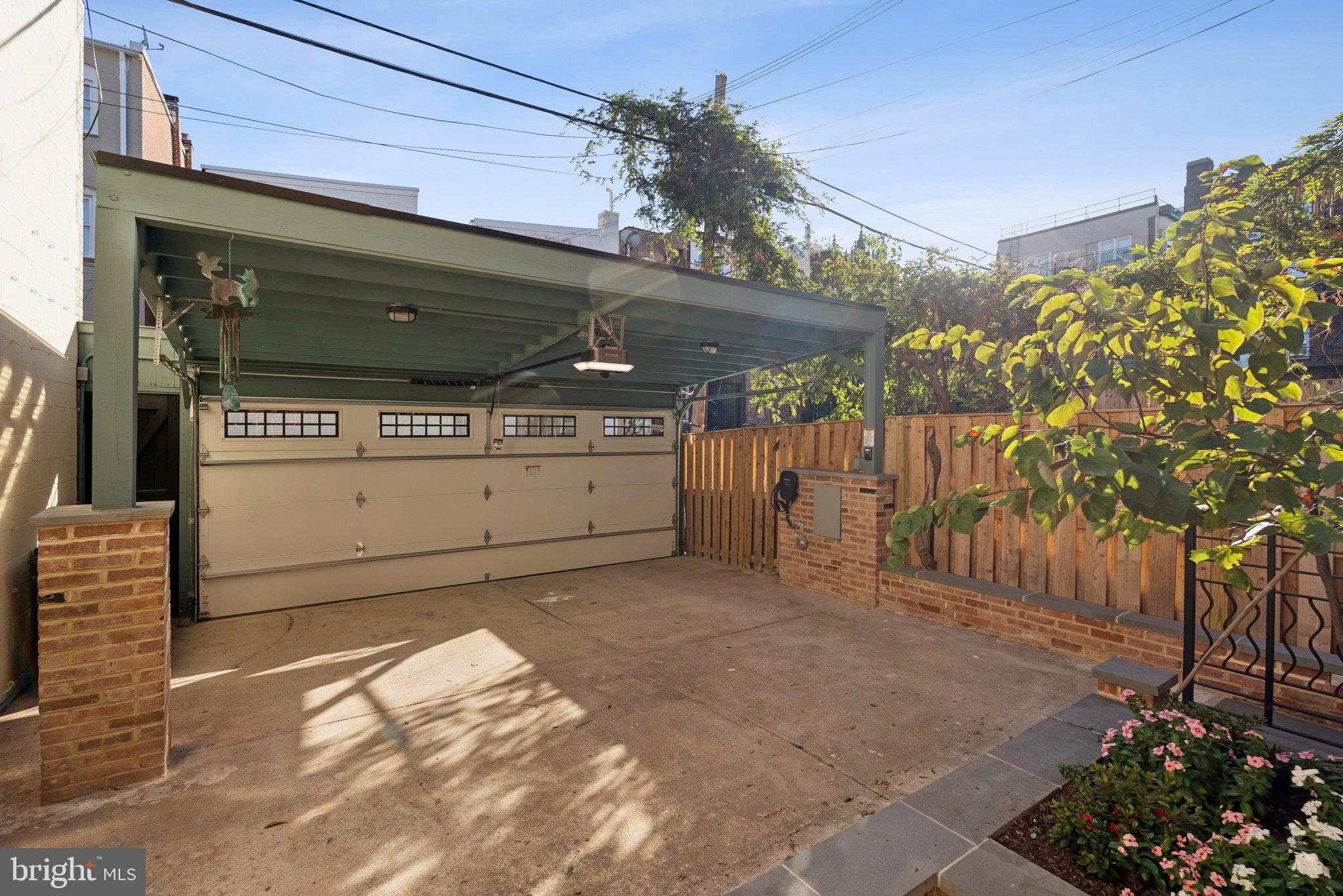 1514 R Street Northwest Washington, DC 20009 - Photo 74 of 84 Charming carport with lush greenery backdrop.