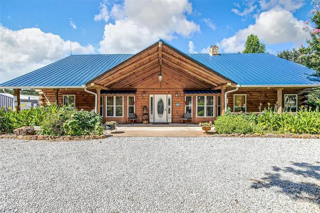 an aerial view of a house with swimming pool garden and outdoor seating