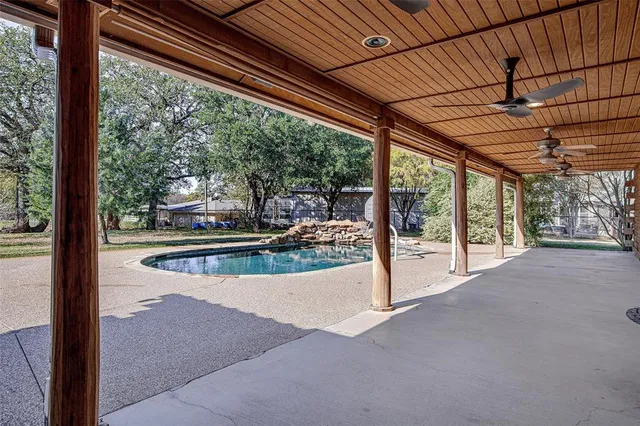 a view of a swimming pool with a porch