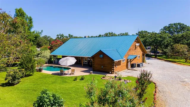 an aerial view of a houses with a swimming pool