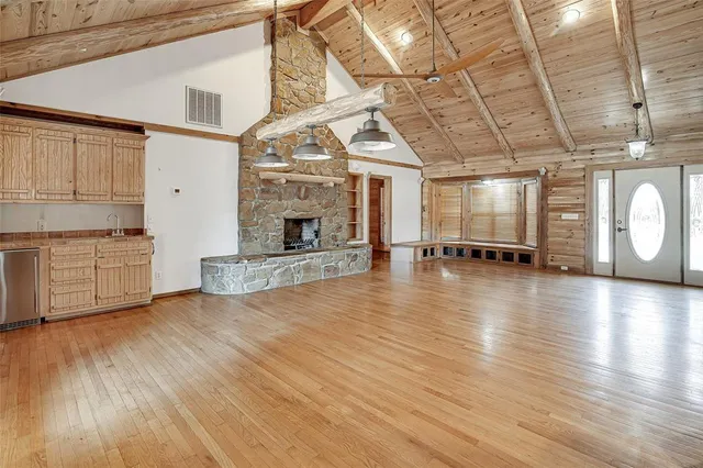 a spacious bathroom with a shower a sink and a mirror
