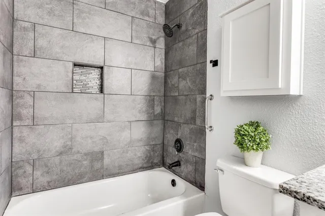 a bathroom with a bathtub and shower