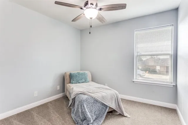 a bathroom with a granite countertop bathtub sink vanity and toilet