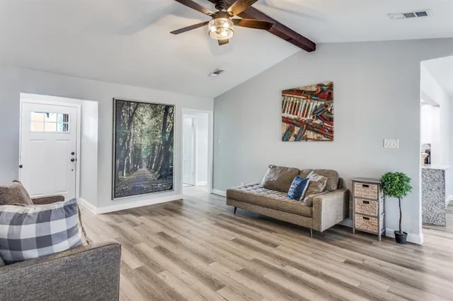 a living room with furniture and a chandelier