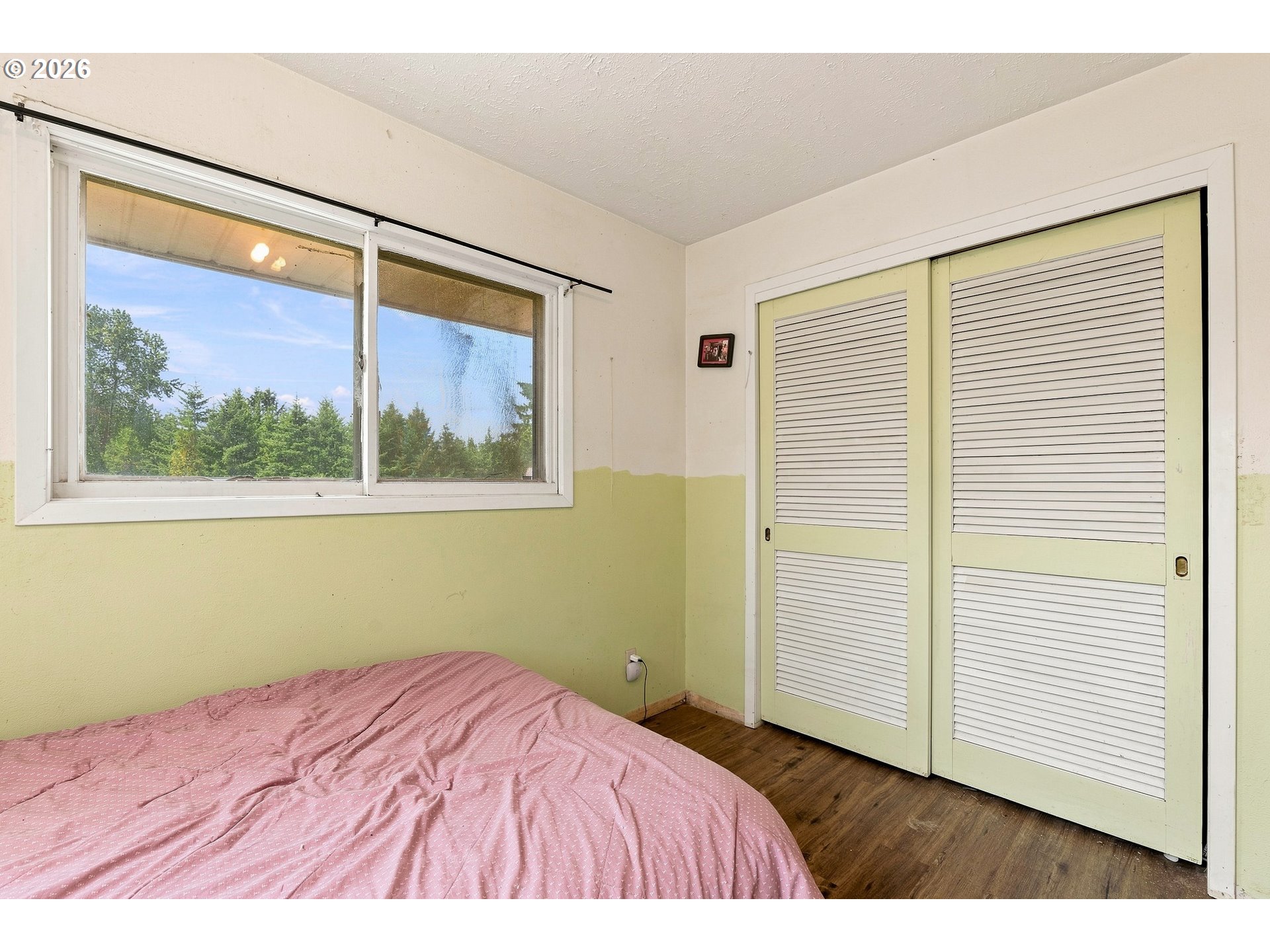 68763 Wasser Road Rainier, OR 97048 - Photo 15 of 42 a bedroom with a bed and a painting on the wall