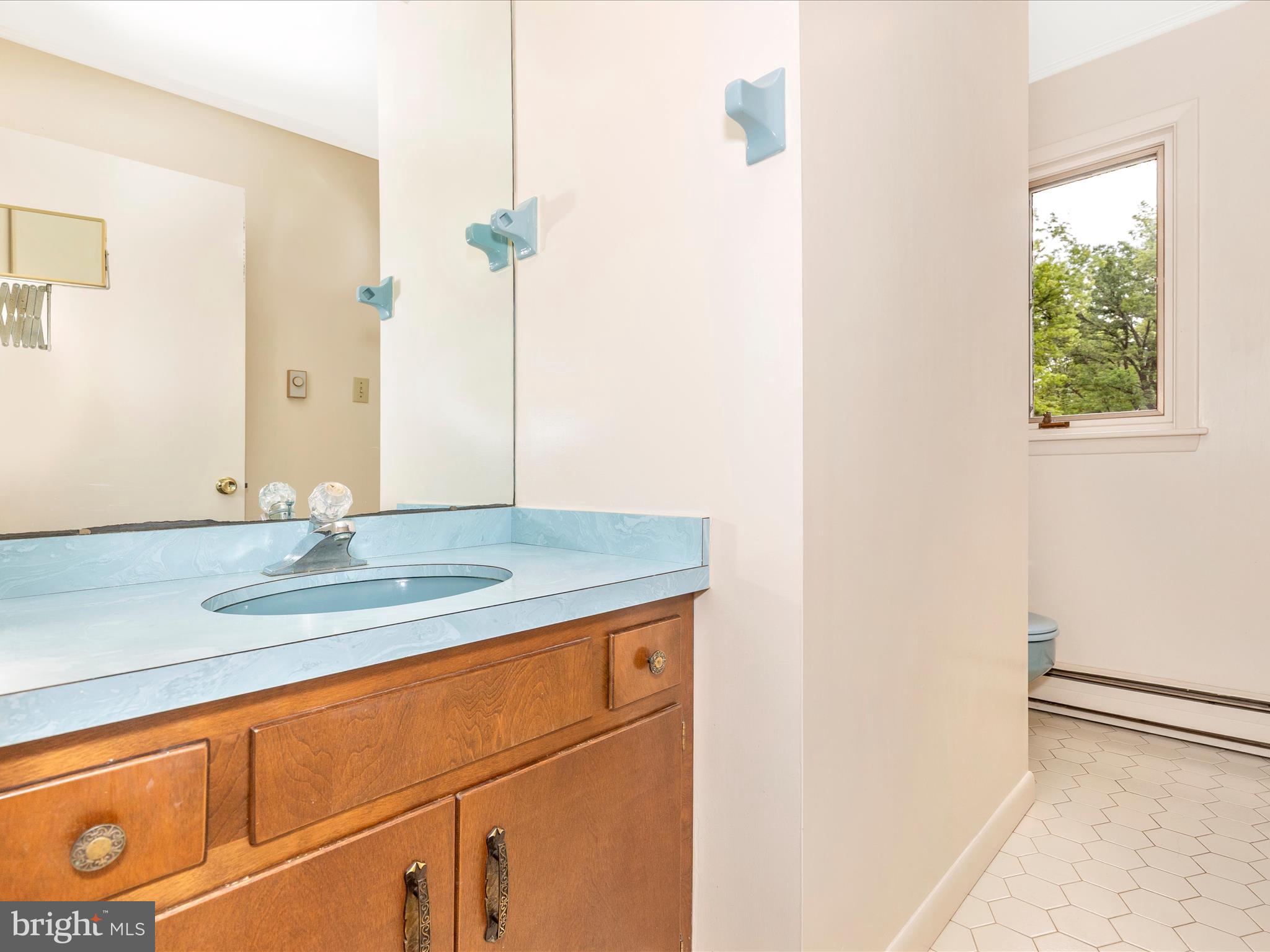 7903 Runnymeade Drive Frederick, MD 21702 - Photo 33 of 51 a bathroom with a granite countertop sink and a mirror