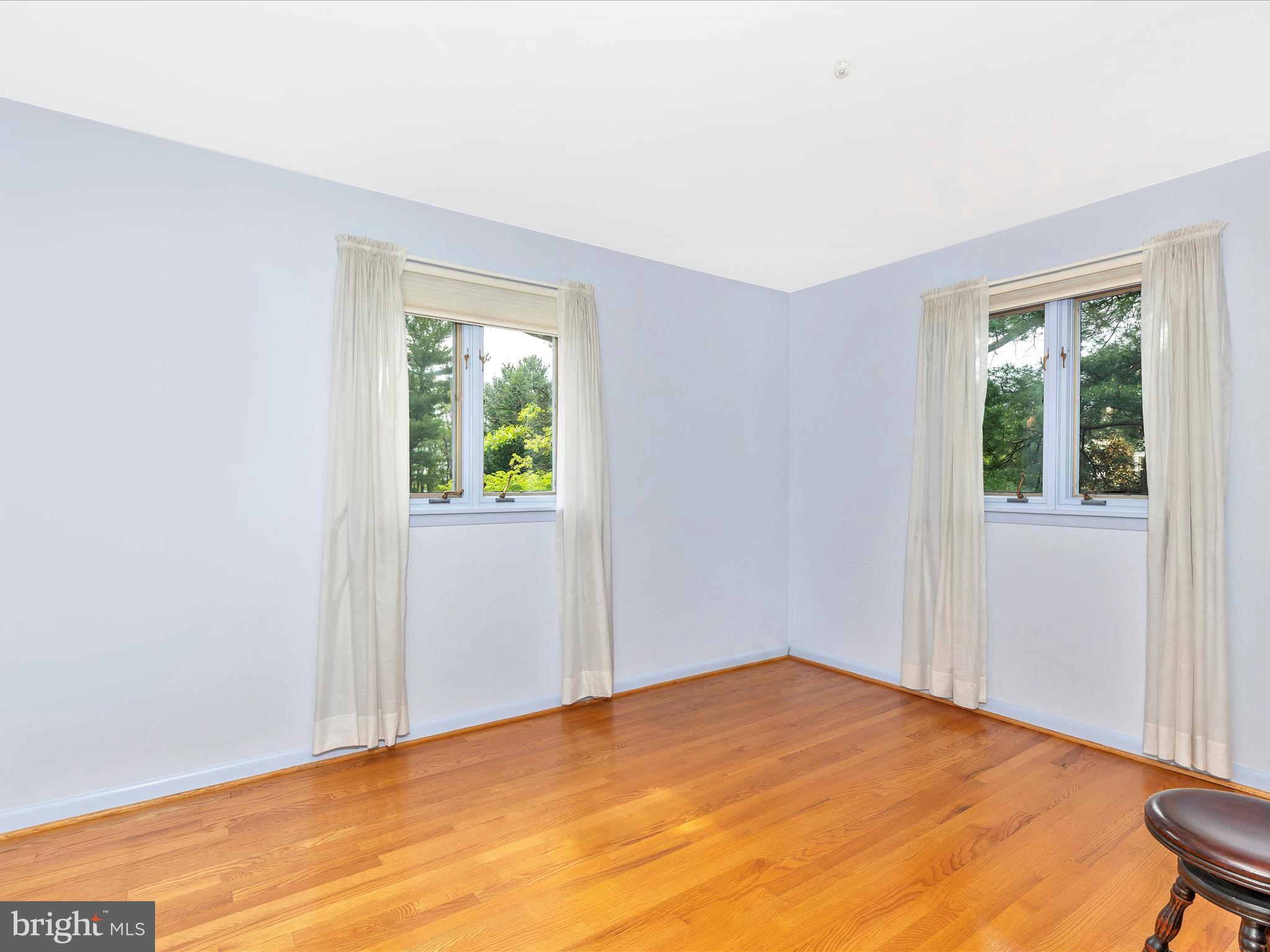 7903 Runnymeade Drive Frederick, MD 21702 - Photo 34 of 51 a view of an empty room with wooden floor and a window