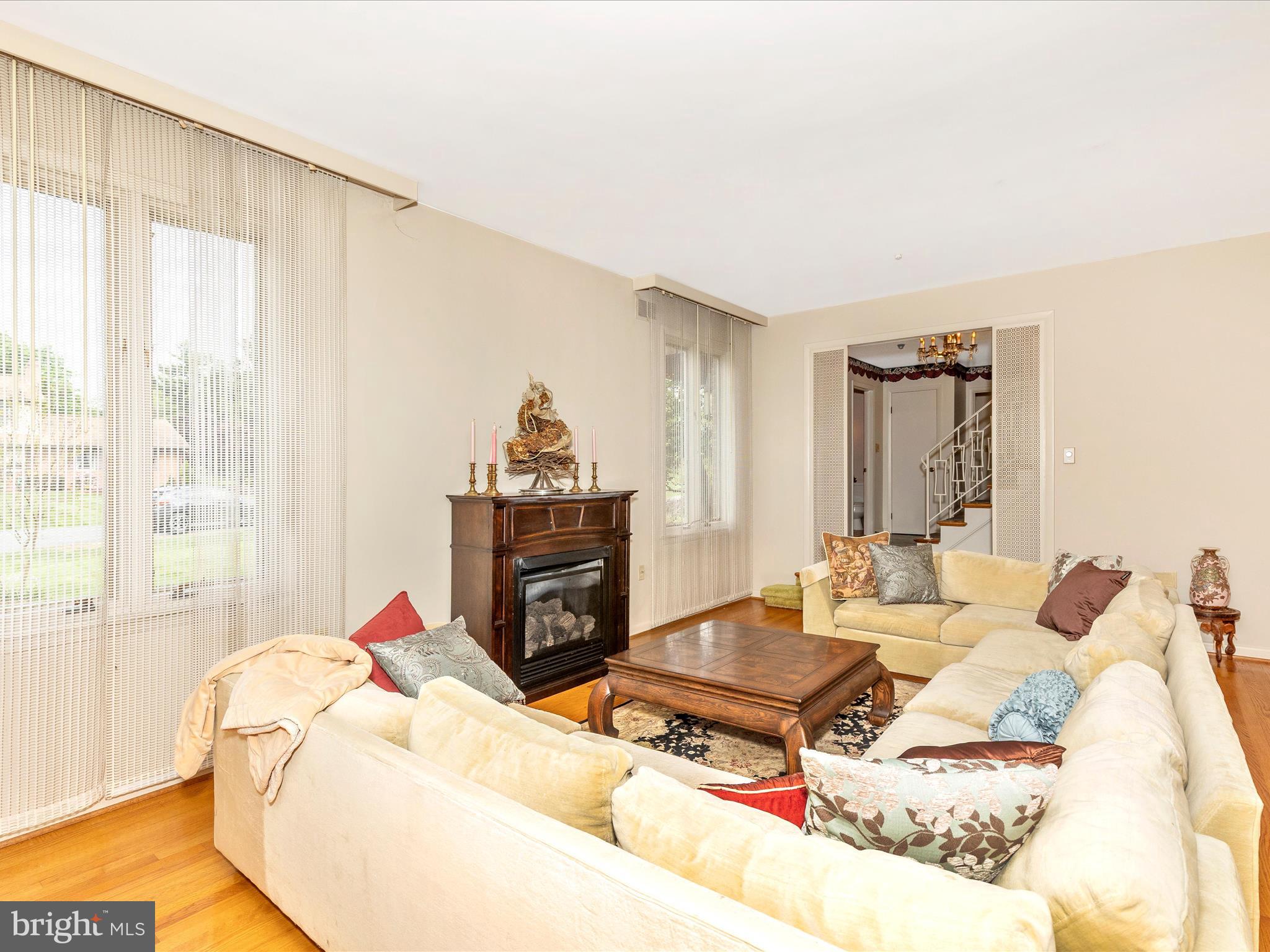 7903 Runnymeade Drive Frederick, MD 21702 - Photo 9 of 51 a living room with furniture a fireplace and a table