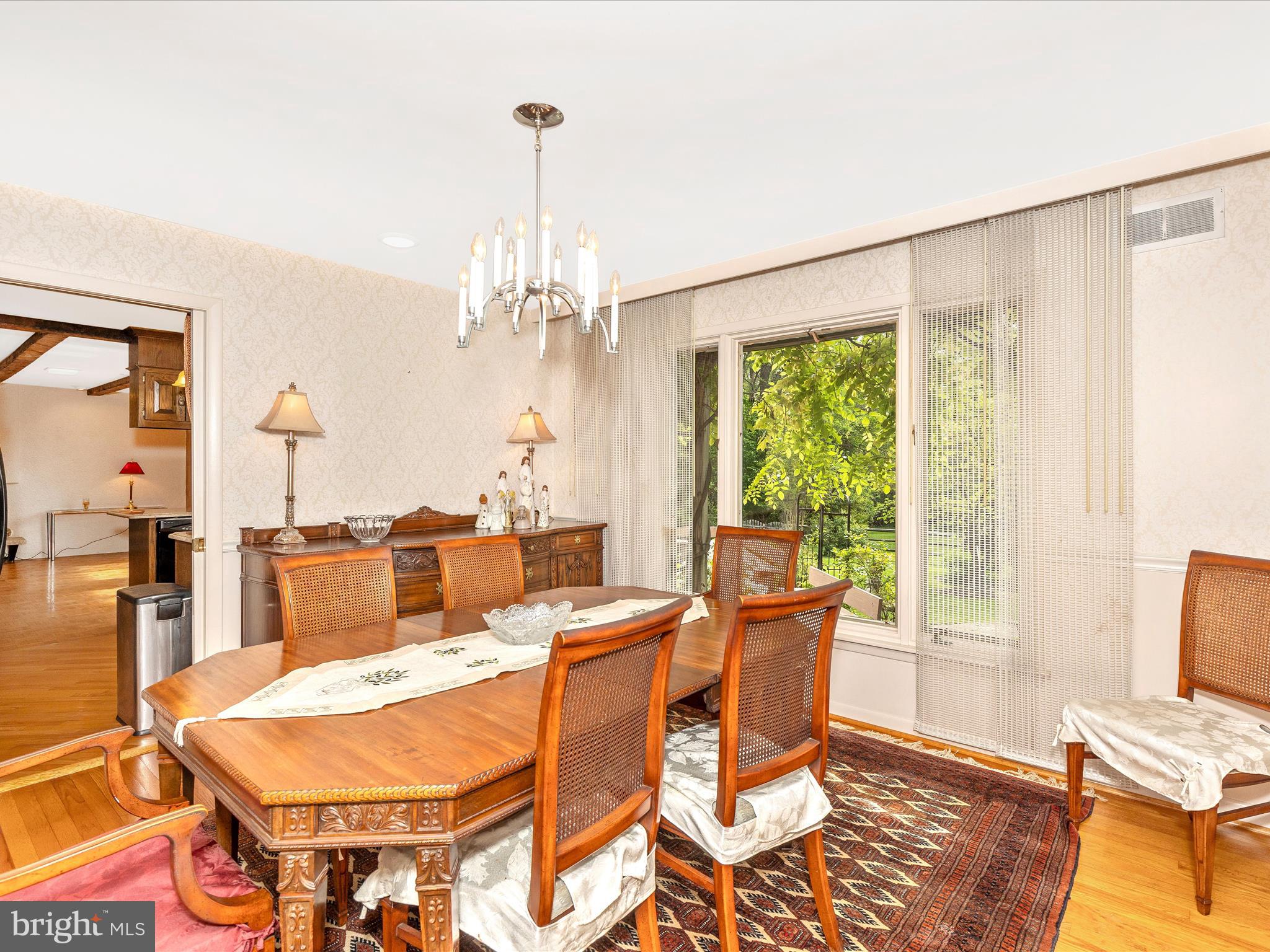 7903 Runnymeade Drive Frederick, MD 21702 - Photo 10 of 51 a dining room with furniture a chandelier and wooden floor
