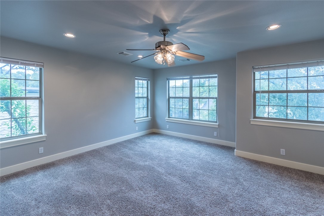 306 East 34th Street, Unit A Austin, TX 78705 - Photo 11 of 28 an empty room with windows and ceiling fan