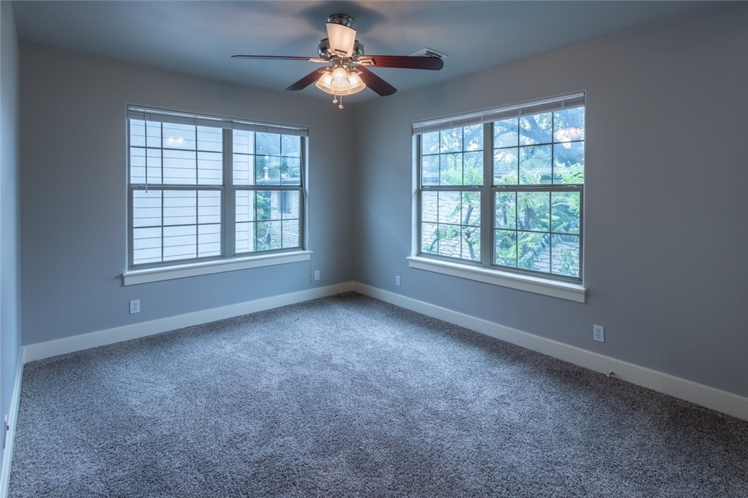 306 East 34th Street, Unit A Austin, TX 78705 - Photo 19 of 28 an empty room with chandelier fan and windows