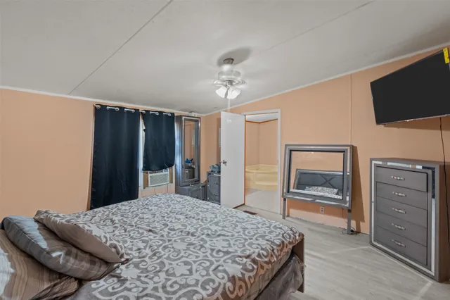 a bedroom with a bed and a flat screen tv