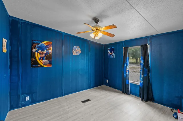 wooden floor in a hall with a painting on the wall