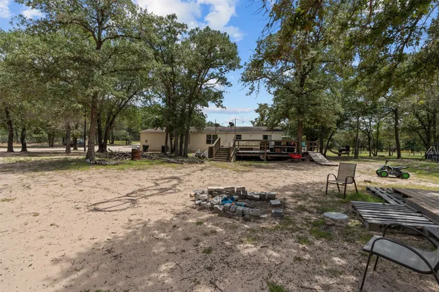 a view of a park with bench and trees