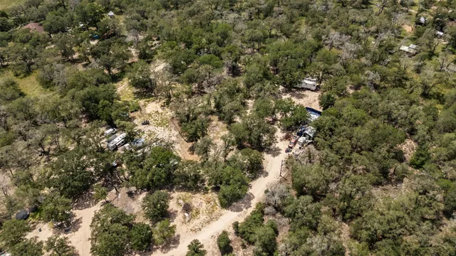 a view of a field of grass and trees