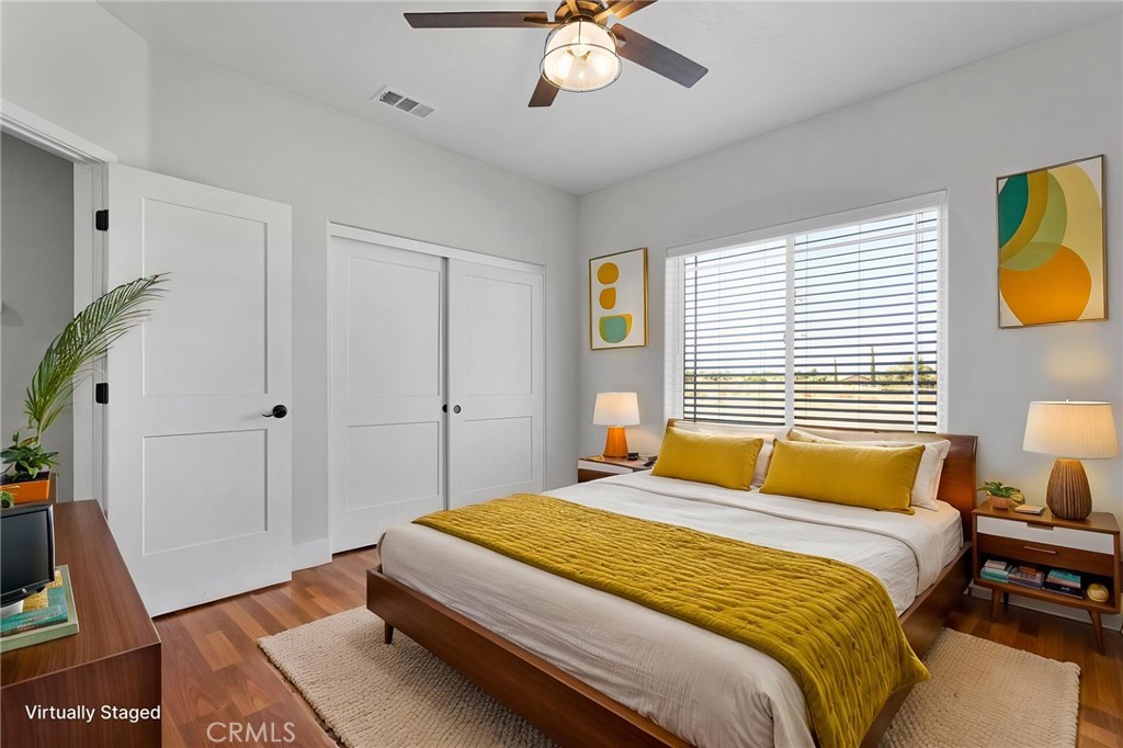 10055 Eaby Road Phelan, CA 92371 - Photo 15 of 19 a bedroom with a bed and a chandelier