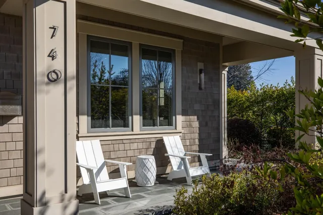 a view of a chair and table in front of house
