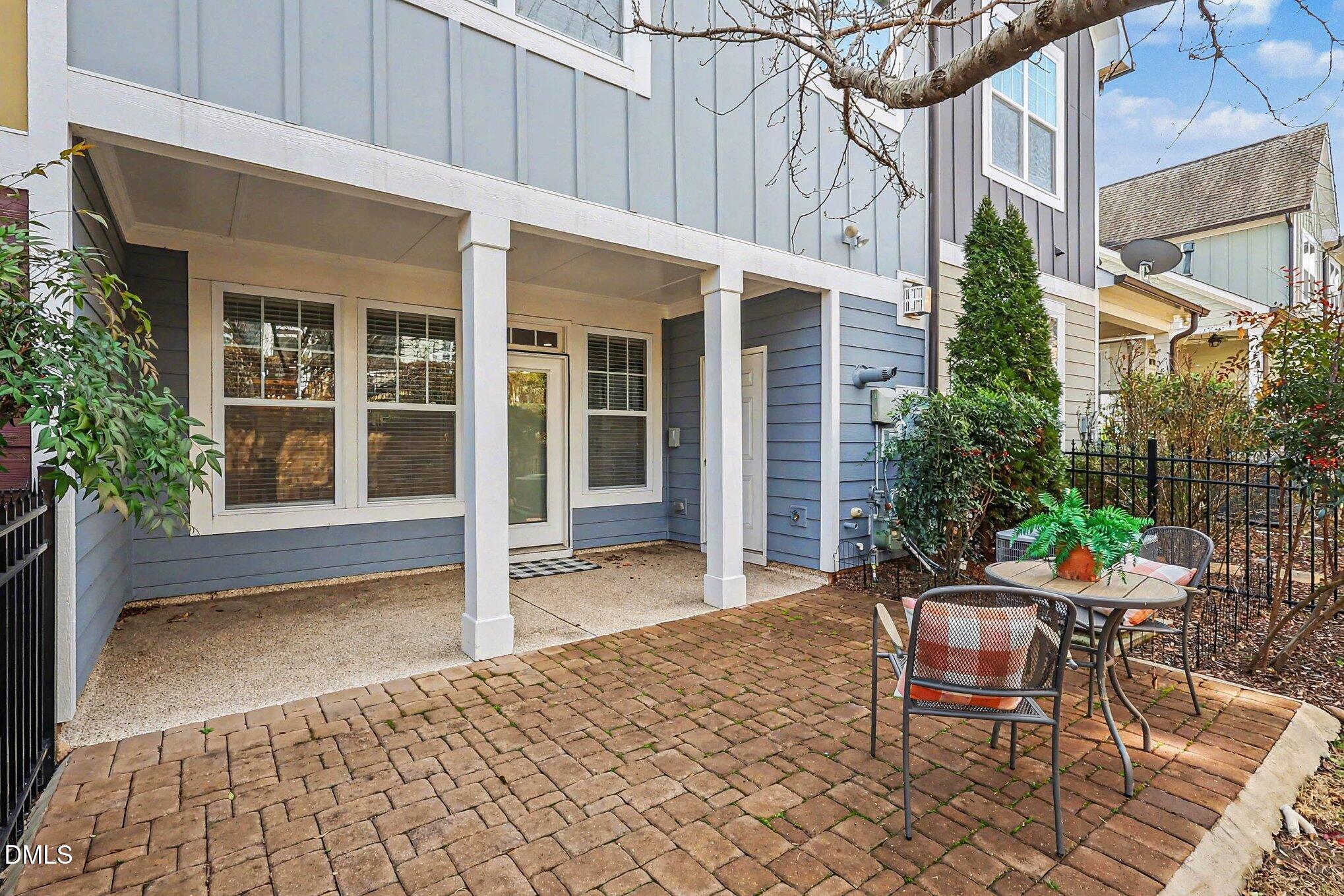 653 Fallon Grove Way Raleigh, NC 27608 - Photo 30 of 38 a view of a patio with table and chairs and potted plants