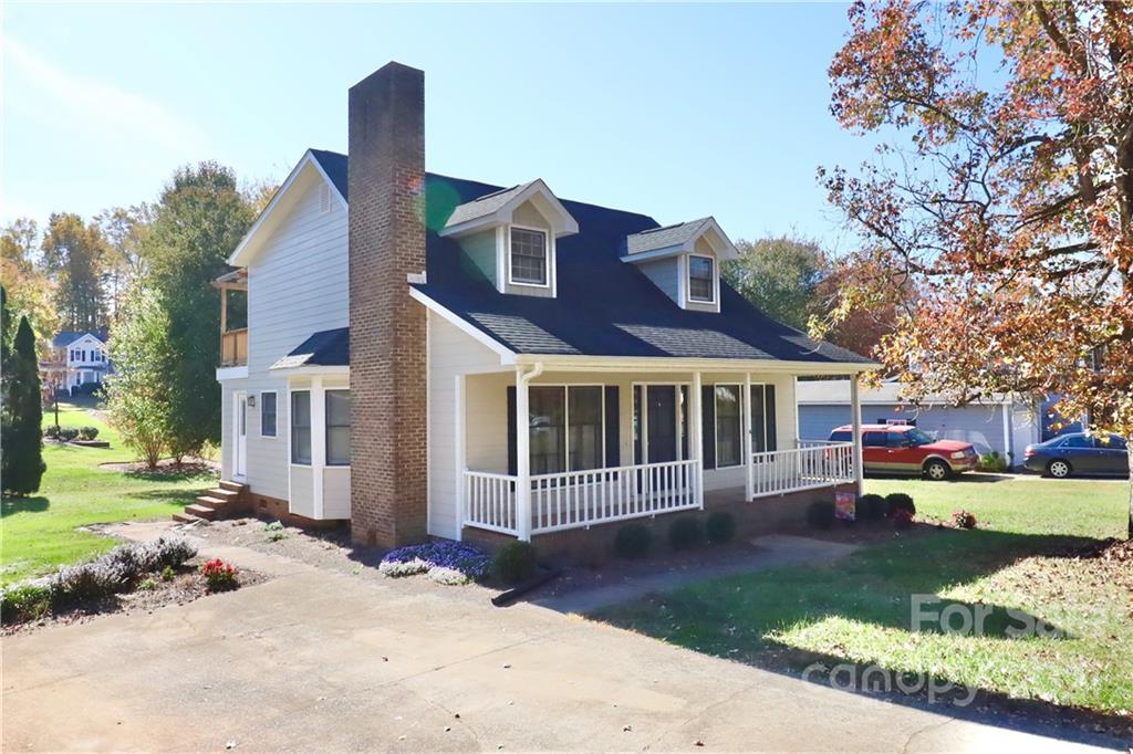 a view of a house with a yard and sitting area