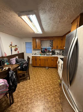 a kitchen with a sink appliances and a window