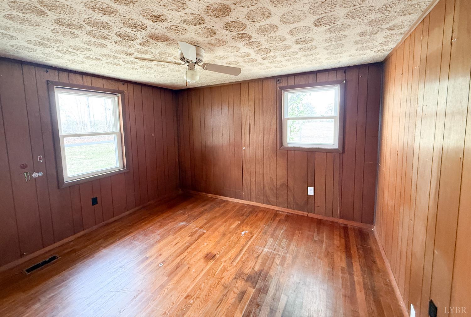 6218 Old Evergreen Road Appomattox, VA 24522 - Photo 6 of 11 an empty room with wooden floor and windows