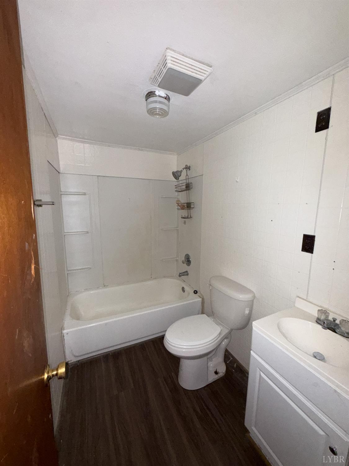 6218 Old Evergreen Road Appomattox, VA 24522 - Photo 7 of 11 a bathroom with a sink toilet a bathtub and a shower