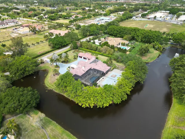 an aerial view of a house with yard swimming pool and outdoor seating