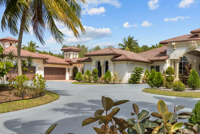 an aerial view of residential house with outdoor space and swimming pool