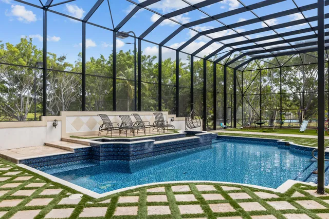 an aerial view of a house with a yard basket ball court and outdoor seating