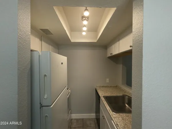 a kitchen with a refrigerator and a stove top oven