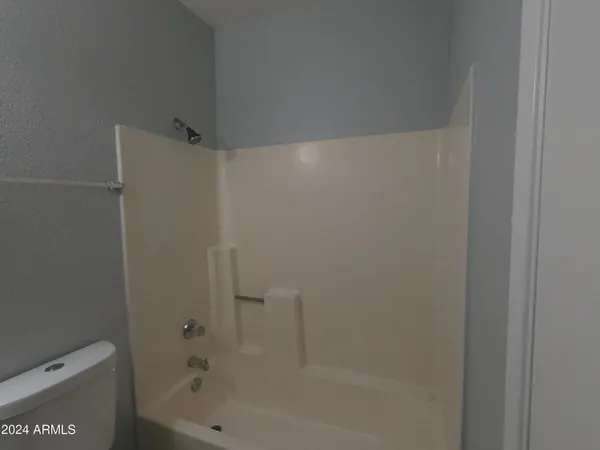 a white toilet sitting next to a bathroom sink