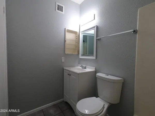a bathroom with a sink toilet and mirror