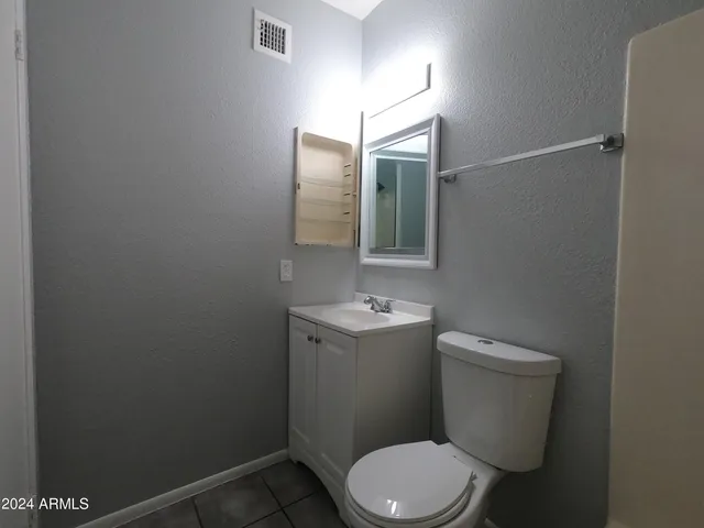 a bathroom with a sink toilet and mirror